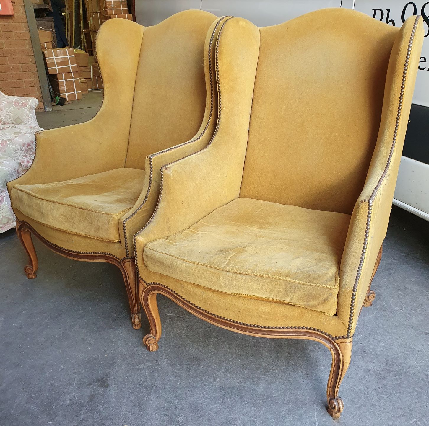 A large pair of Louis XV Bergere Wing Armchairs